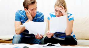 Worried Couple Looking at Bills